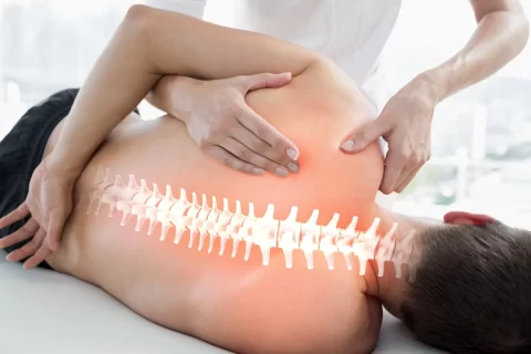 Chiropractor performing a hands-on spinal adjustment, a technique used to address sciatica and disc-related symptoms